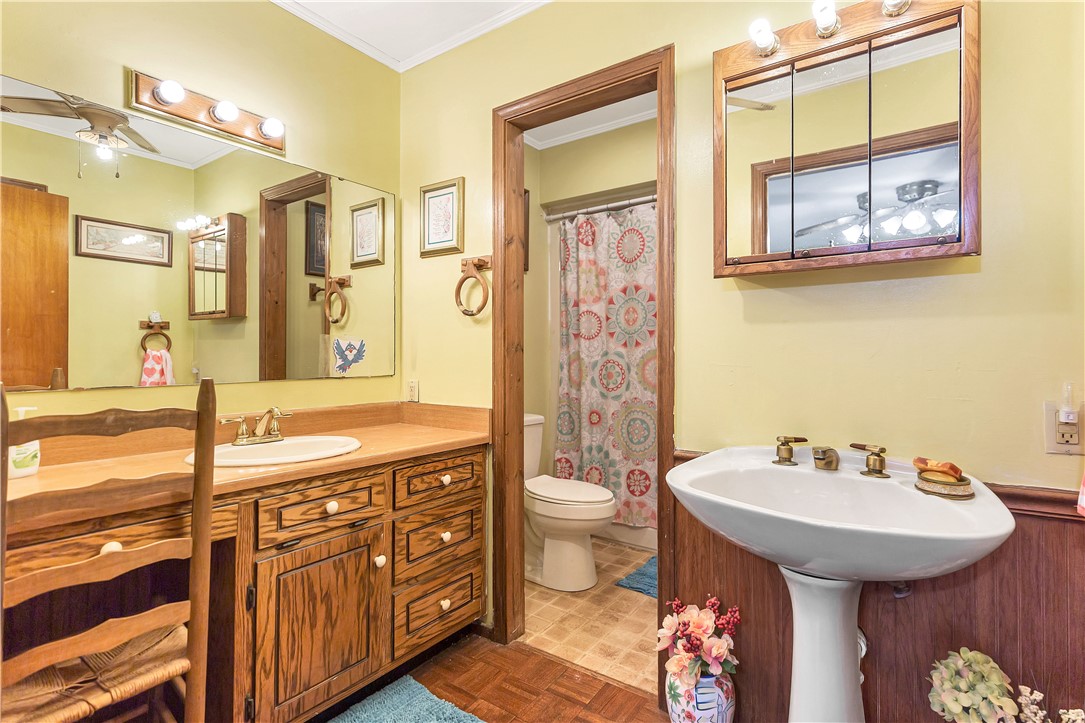 219 Beaty Square Anderson, SC 29624 - Photo 20 of 32 This bathroom features dual vanity spaces, a separate toilet area, and a classic pedestal sink.