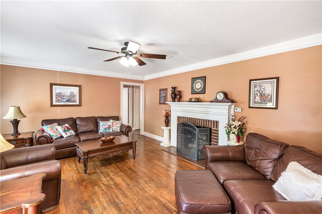 219 Beaty Square Anderson, SC 29624 - Photo 4 of 32 This inviting living room boasts warm hardwood flooring and a classic fireplace, perfect for cozy gatherings.