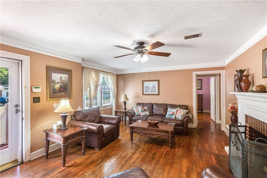 219 Beaty Square Anderson, SC 29624 - Photo 5 of 32 This warm living space features rich hardwood flooring and a classic brick fireplace.