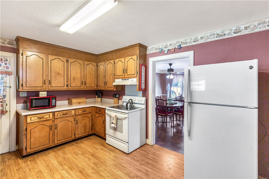219 Beaty Square Anderson, SC 29624 - Photo 10 of 32 This cozy kitchen features abundant wood cabinetry and easy access to the dining area.