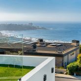 a front view of a building with a garden