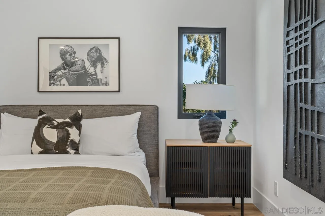 8433 Prestwick Drive La Jolla, CA 92037 - Photo 16 of 74 a bedroom with a bed and a painting on the wall