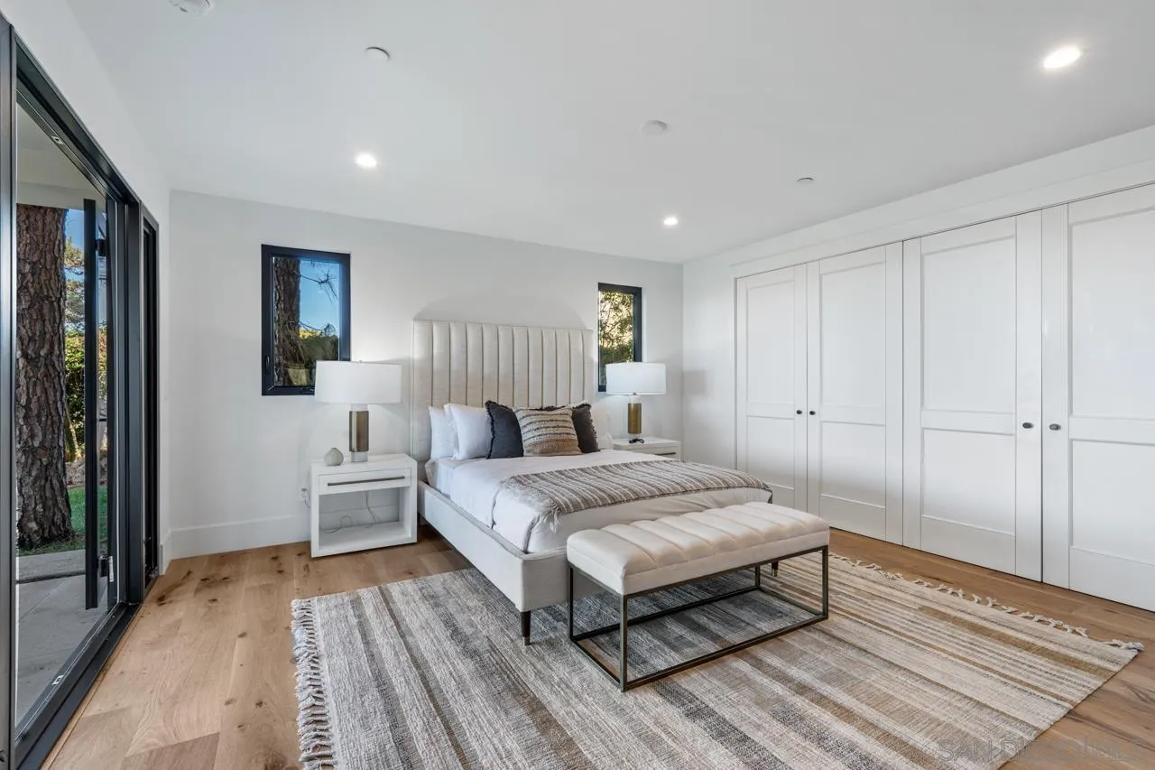 8433 Prestwick Drive La Jolla, CA 92037 - Photo 17 of 74 a spacious bedroom with a bed and wooden floor