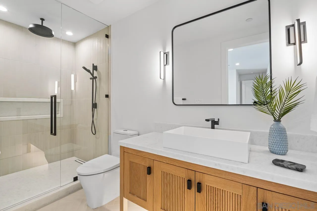 8433 Prestwick Drive La Jolla, CA 92037 - Photo 22 of 74 a bathroom with a sink a toilet and a mirror