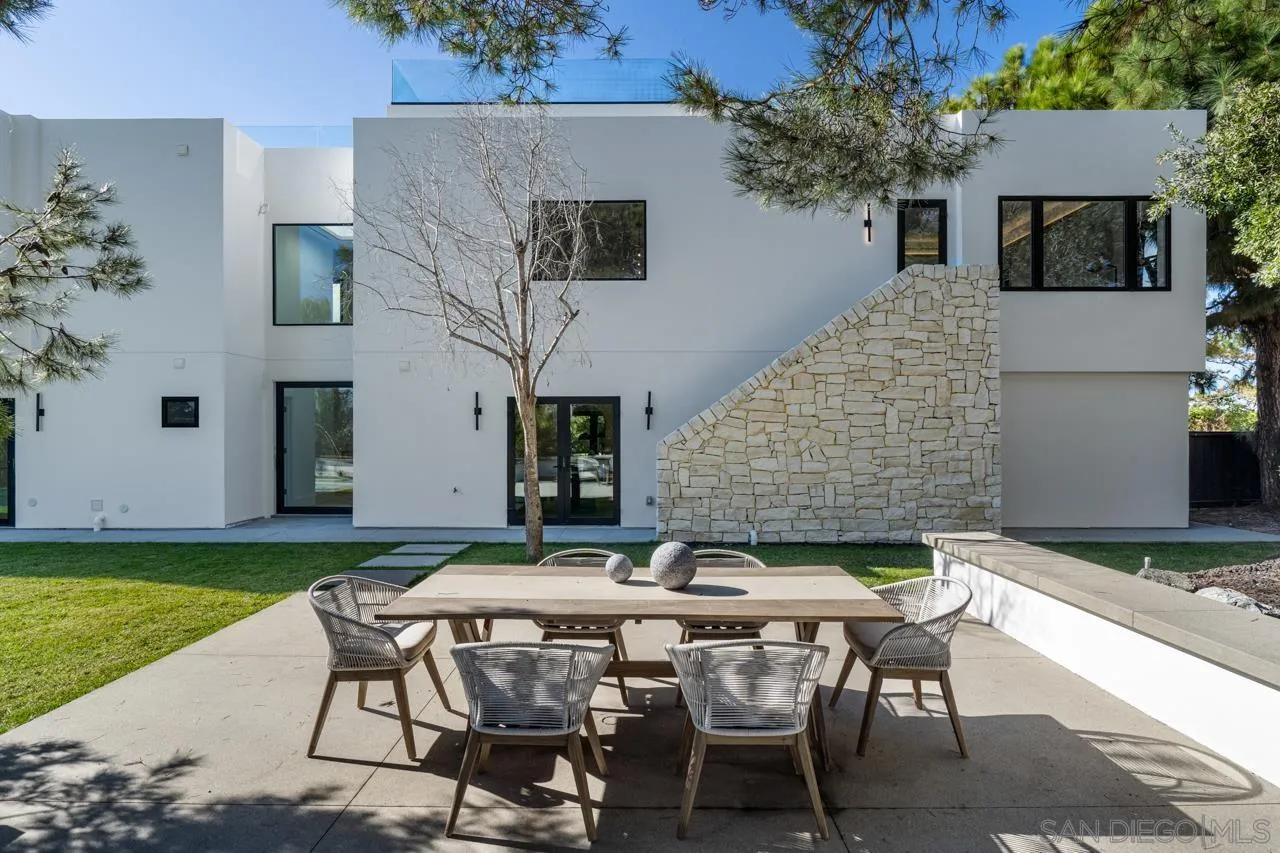8433 Prestwick Drive La Jolla, CA 92037 - Photo 25 of 74 a backyard of a house with table and chairs