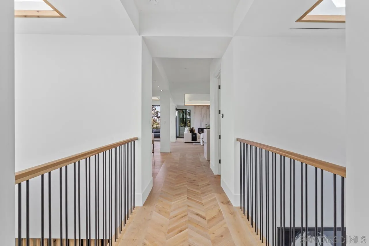 8433 Prestwick Drive La Jolla, CA 92037 - Photo 30 of 74 a view of a hallway with wooden floor and a bathroom