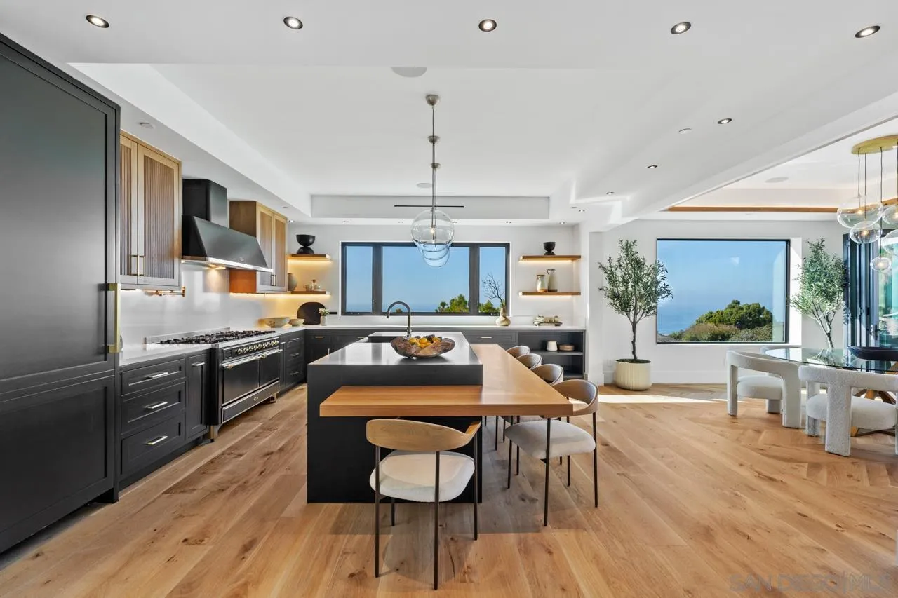 8433 Prestwick Drive La Jolla, CA 92037 - Photo 35 of 74 a kitchen with stainless steel appliances granite countertop sink stove top oven and cabinets