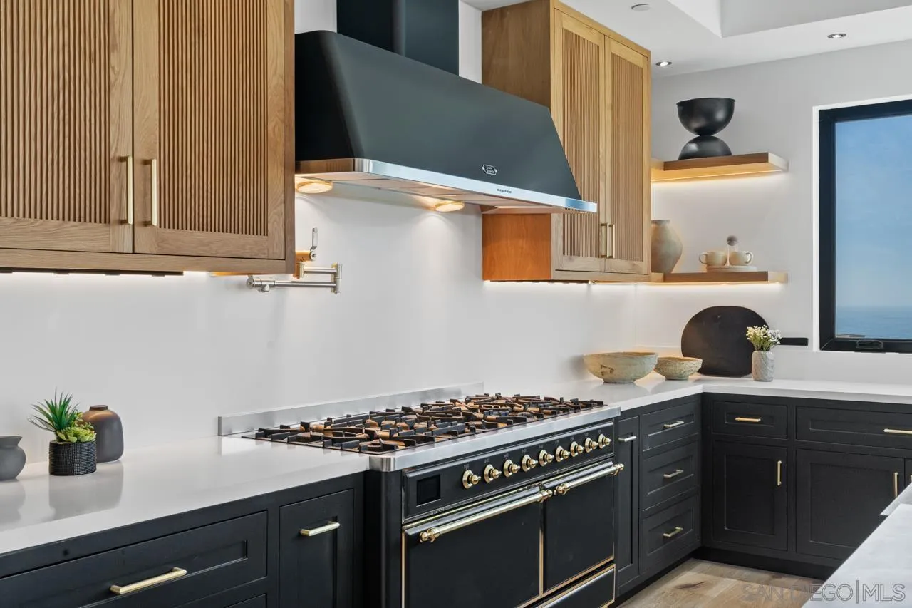 8433 Prestwick Drive La Jolla, CA 92037 - Photo 38 of 74 a kitchen with stainless steel appliances a stove a sink and a refrigerator