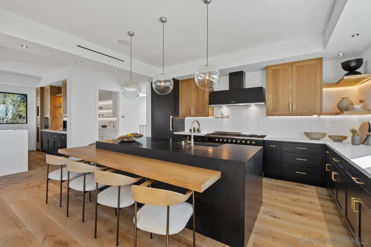 8433 Prestwick Drive La Jolla, CA 92037 - Photo 42 of 74 a kitchen with a table chairs sink and cabinets