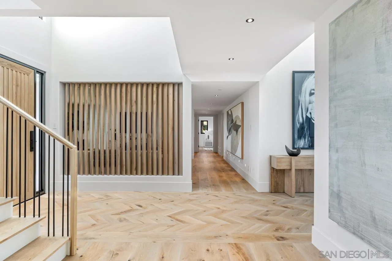 8433 Prestwick Drive La Jolla, CA 92037 - Photo 5 of 74 a view of a hallway with wooden floor and stairs
