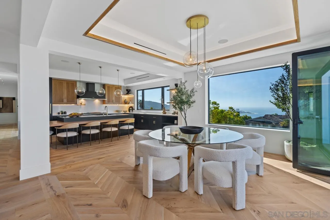 8433 Prestwick Drive La Jolla, CA 92037 - Photo 51 of 74 a dining room with furniture and a chandelier