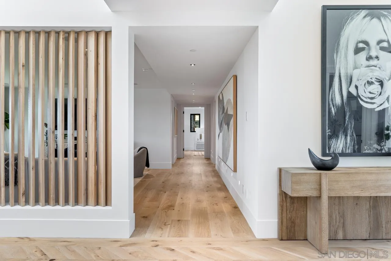 8433 Prestwick Drive La Jolla, CA 92037 - Photo 6 of 74 a view of a hallway with wooden floor and door
