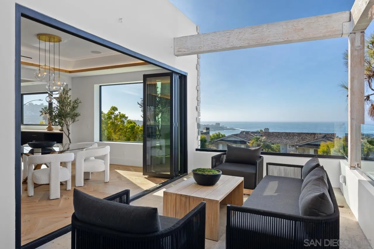 8433 Prestwick Drive La Jolla, CA 92037 - Photo 62 of 74 a view of a dining room with furniture large windows and a potted plant