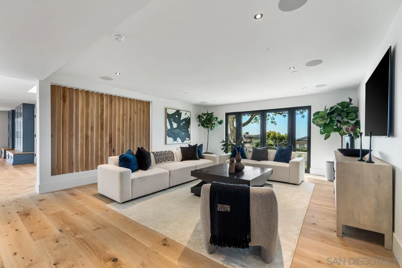 8433 Prestwick Drive La Jolla, CA 92037 - Photo 7 of 74 a living room with furniture large window and flat screen tv