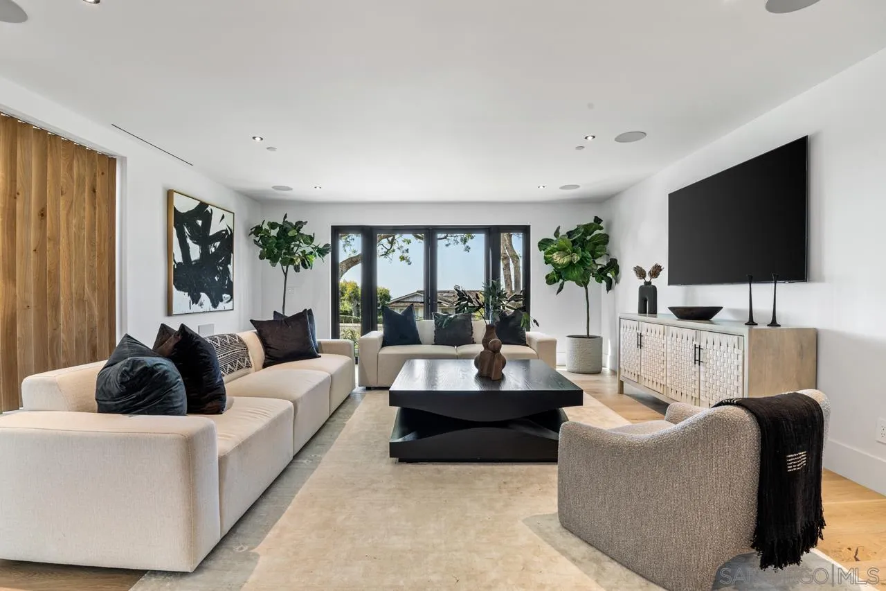 8433 Prestwick Drive La Jolla, CA 92037 - Photo 8 of 74 a living room with furniture and a flat screen tv