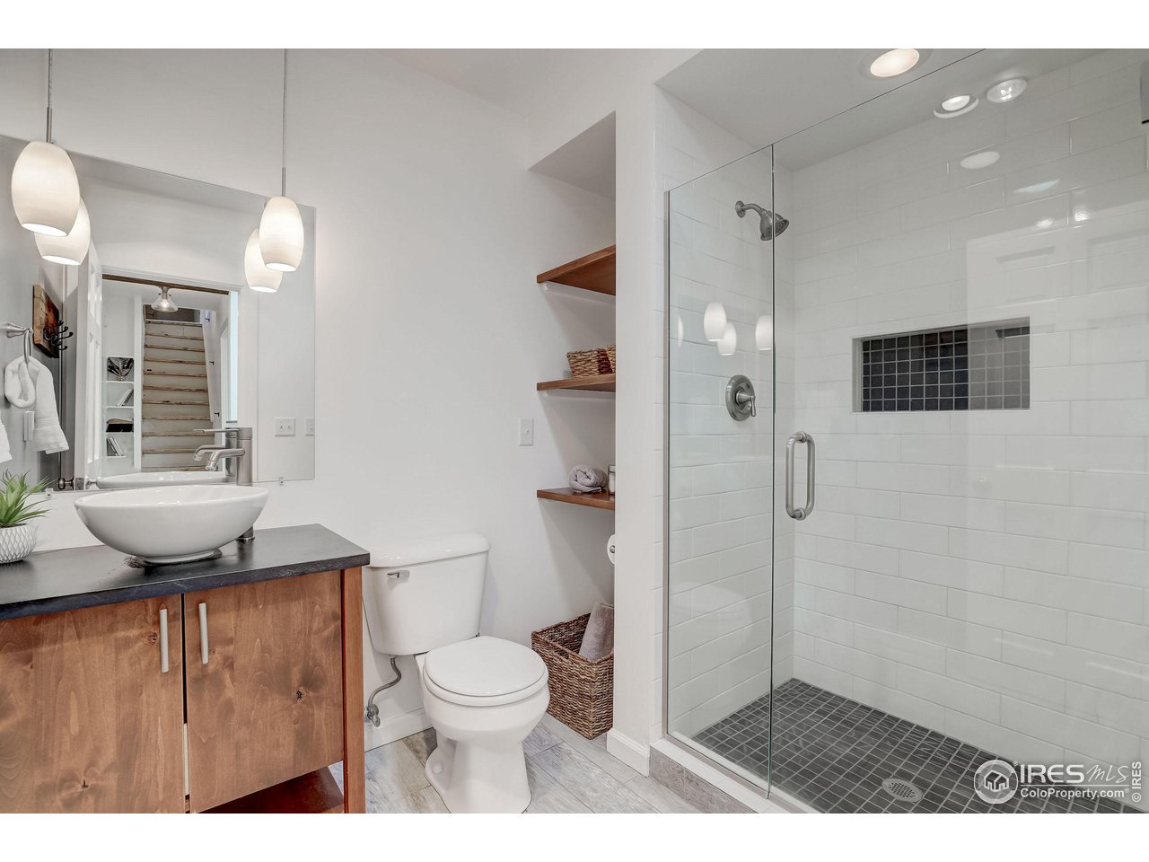 811 County Road 83 Boulder, CO 80302 - Photo 22 of 38 a bathroom with a granite countertop sink toilet a shower and a mirror