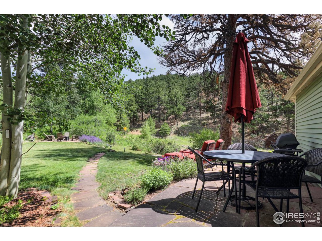 811 County Road 83 Boulder, CO 80302 - Photo 32 of 38 a table and chairs sitting in the garden
