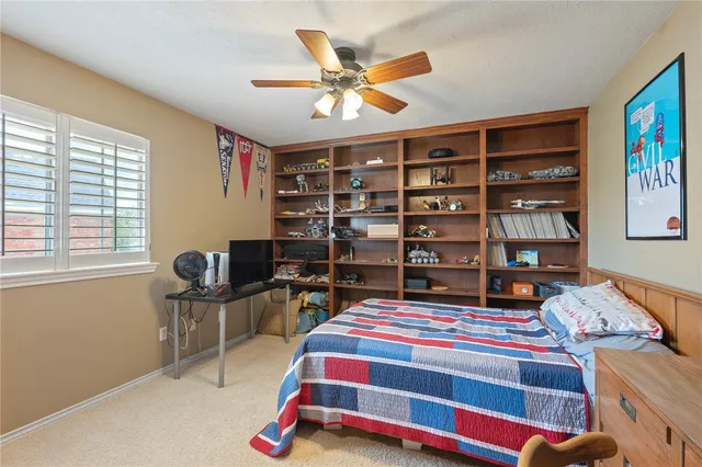 a bedroom with a bed and a book shelf