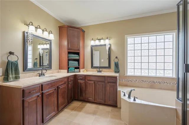 a bathroom with a tub sink and mirror