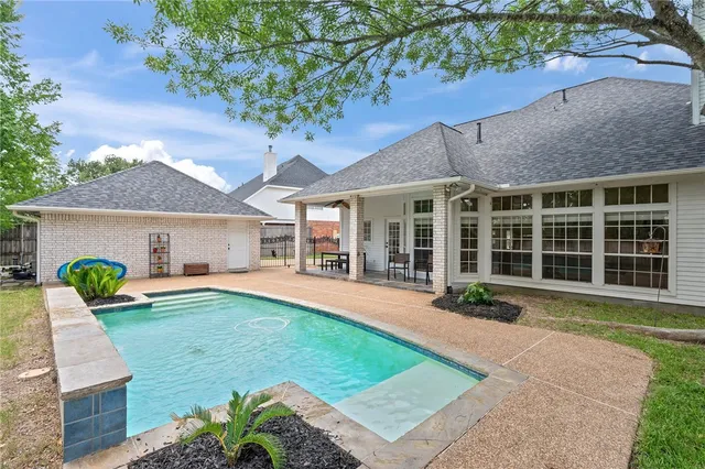 a front view of a house with a garden and porch