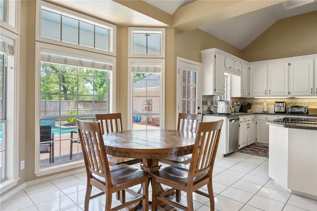 a dining room with a wooden table and chairs
