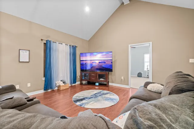 a bedroom with two beds and a flat screen tv