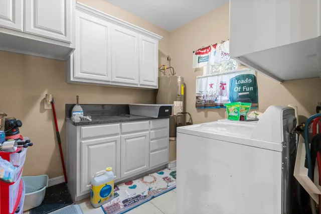 a utility room with fridge and washer