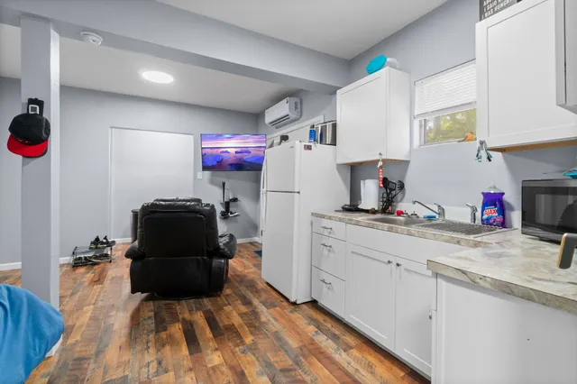 a kitchen with a refrigerator and a stove top oven