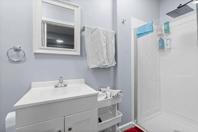 a bathroom with a sink mirror and vanity