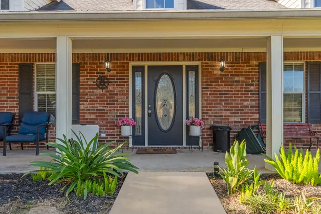 a front view of house with outdoor seating
