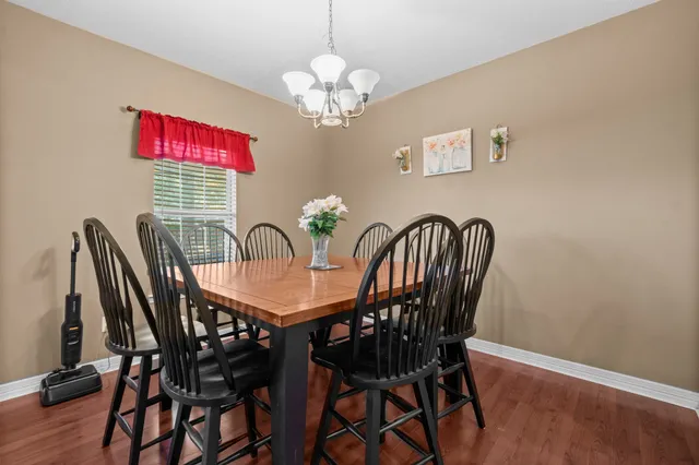 a view of a dining room with furniture and chandelier
