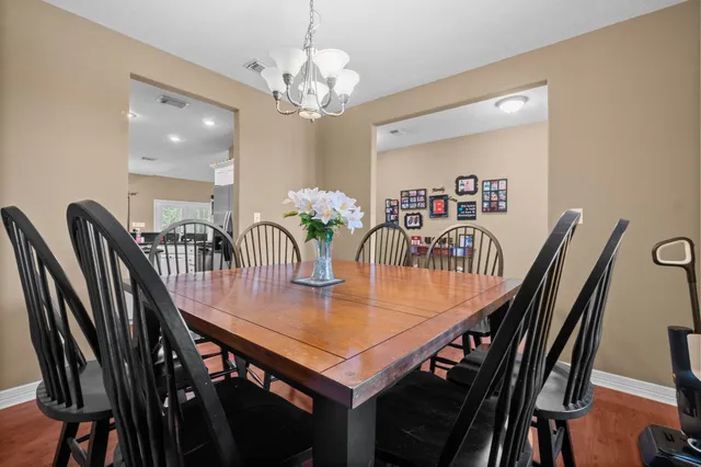 a view of a dining room with furniture and chandelier