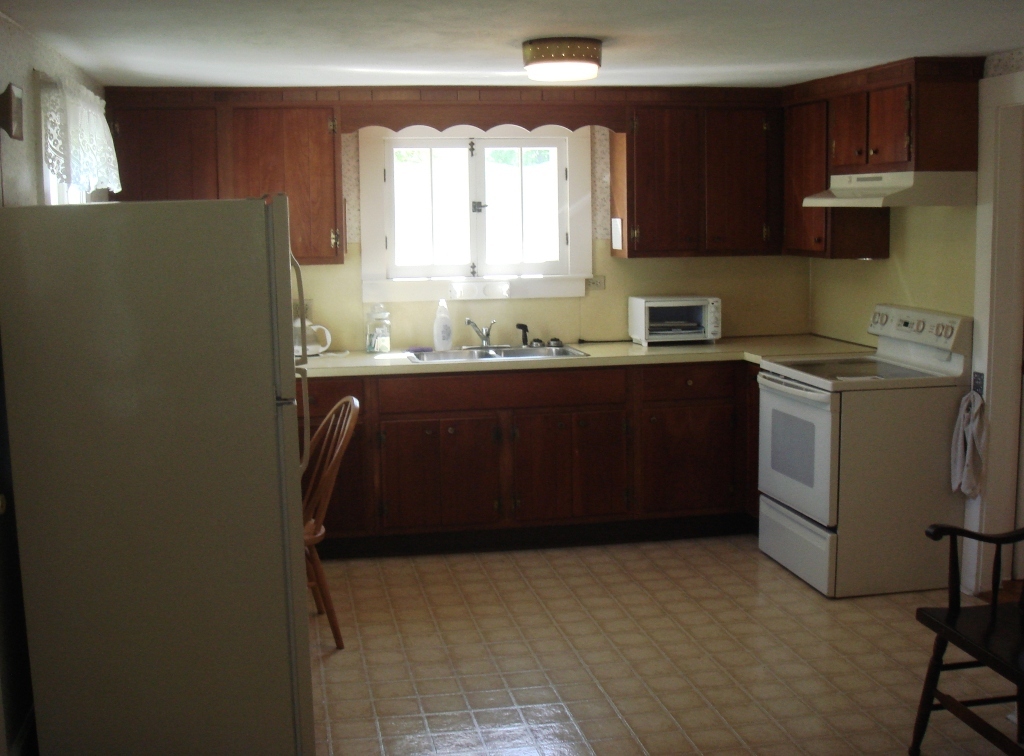 404 Middle Road Clarksburg, MA 01247 - Photo 4 of 16 a kitchen with a refrigerator sink and cabinets