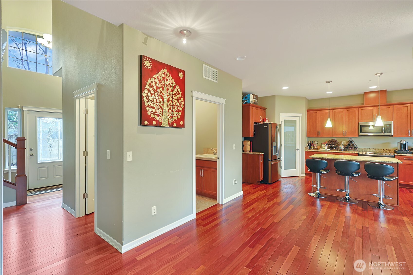 11107 Southeast 162nd Street, Unit B Renton, WA 98055 - Photo 6 of 15 a view of kitchen with stainless steel appliances refrigerator stove and wooden floor