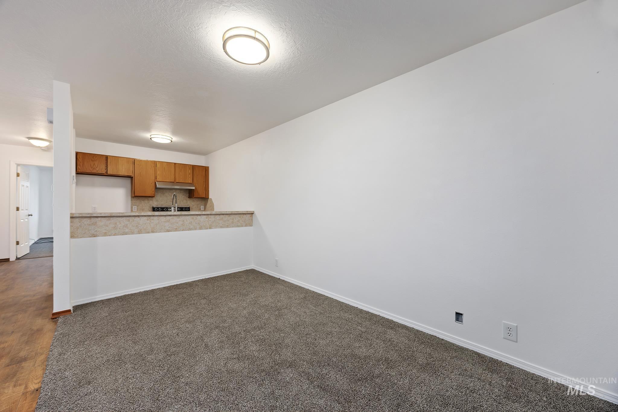 511 Union Avenue Filer, ID 83328 - Photo 24 of 25 Kitchen featuring brown cabinetry, light countertops, a peninsula, open floor plan, and backsplash