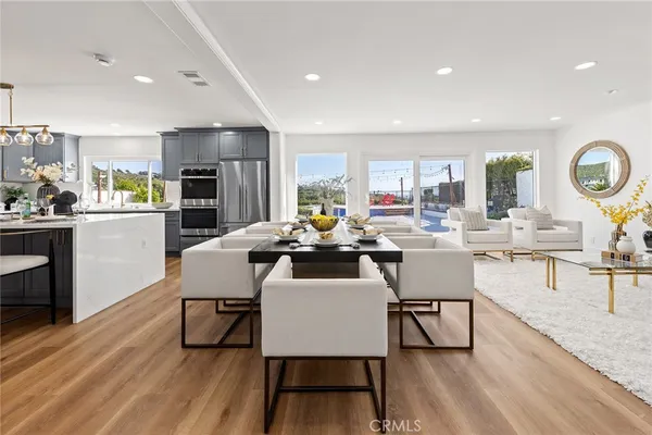 a view of a dining room with furniture and wooden floor
