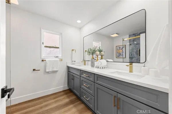 a bathroom with a sink mirror and vanity