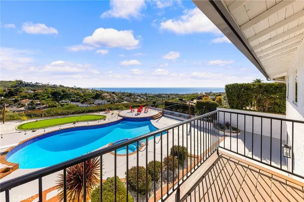 a view of a swimming pool with a table and chairs