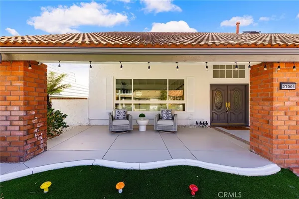 a view of an house with backyard and outdoor seating