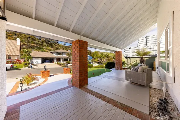 a view of living room with patio furniture and a floor to ceiling window