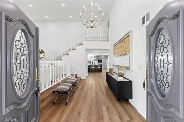 a living room with furniture stairs and a wooden floor