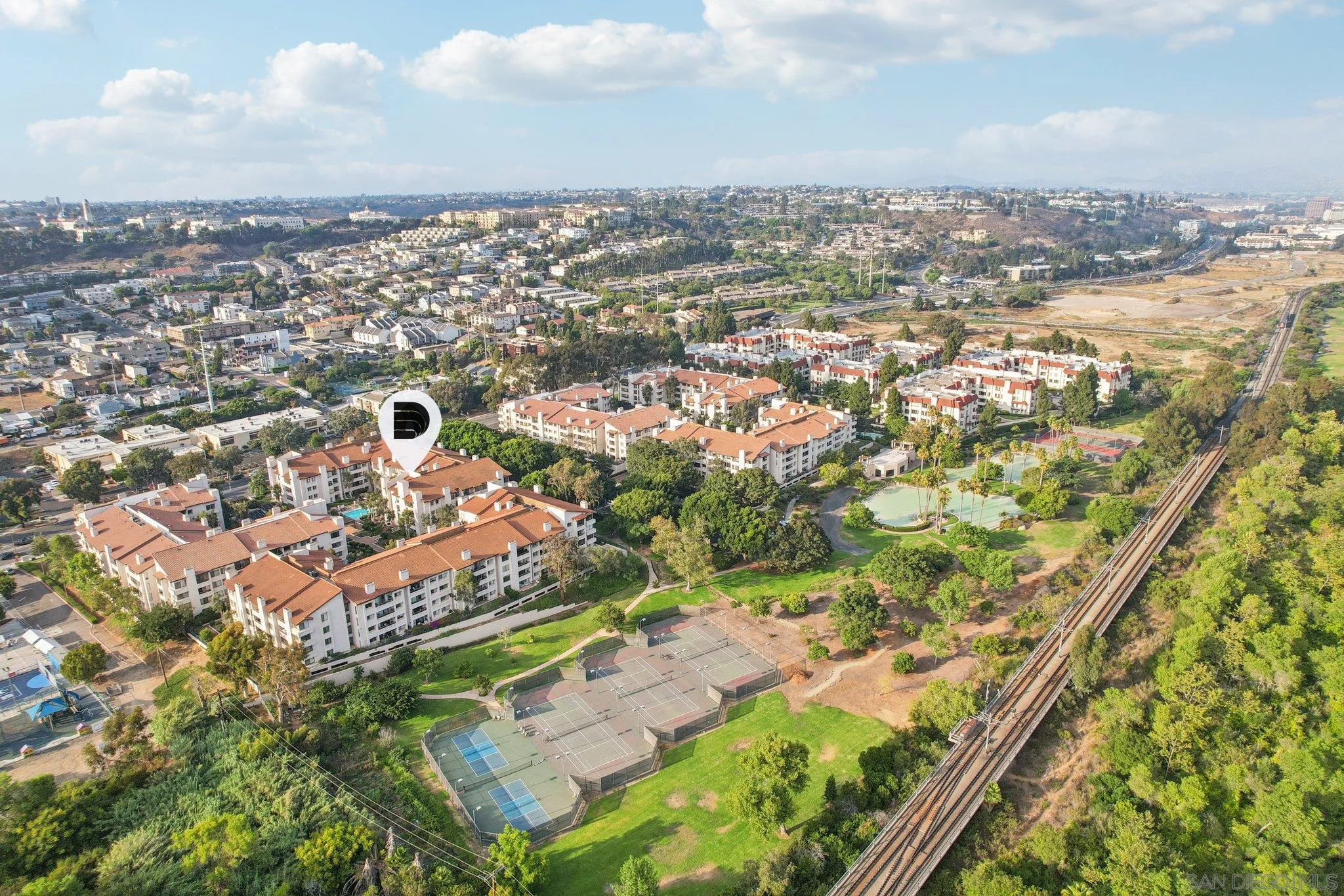 an aerial view of a residential houses with yard