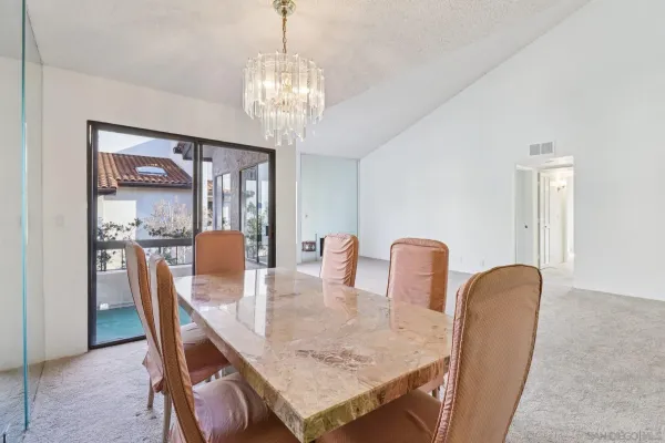 a view of a dining room with furniture and chandelier