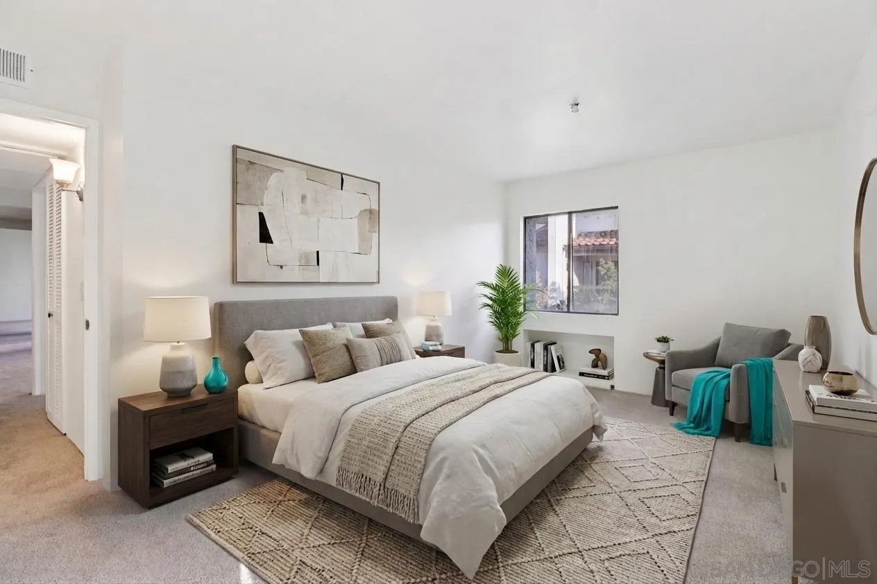 5645 Friars Road, Unit 386 San Diego, CA 92110 - Photo 12 of 72 a bedroom with bed a couch and painting on the wall