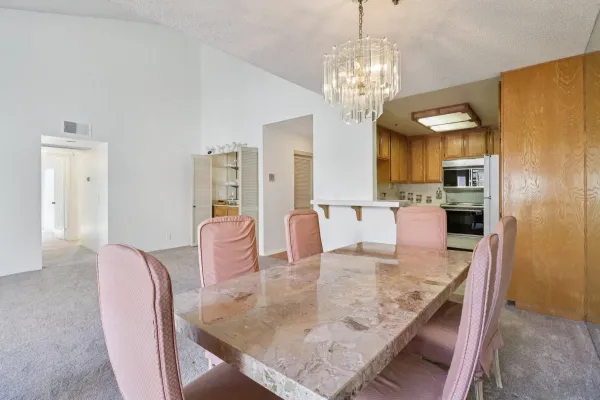 a kitchen with stainless steel appliances granite countertop a refrigerator a sink dishwasher a stove with wooden cabinets