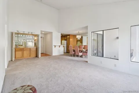 a dining room with furniture a chandelier and window