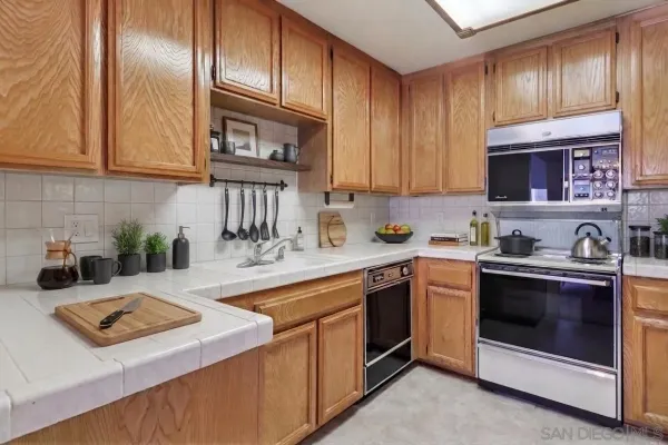 a kitchen with a sink stove and cabinets