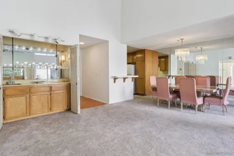 a view of a dining room with furniture and chandelier