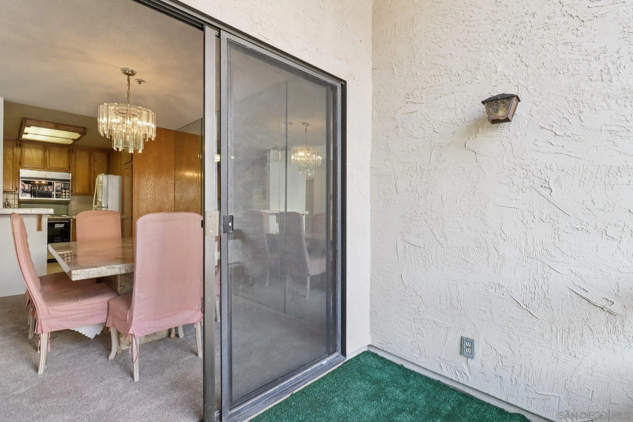 5645 Friars Road, Unit 386 San Diego, CA 92110 - Photo 23 of 72 a view of a dining room with furniture and chandelier
