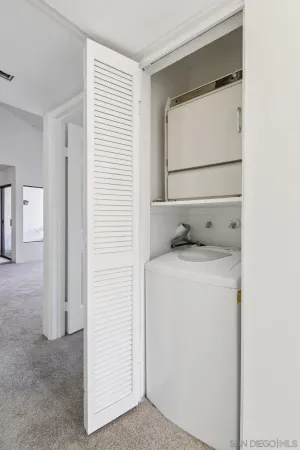 an empty room with closet and a bathroom view